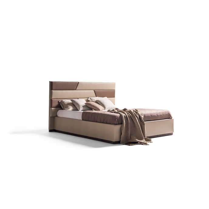A modern platform bed with a padded headboard in shades of taupe and brown, styled with neutral bedding and a draped throw blanket, set against a plain white background.