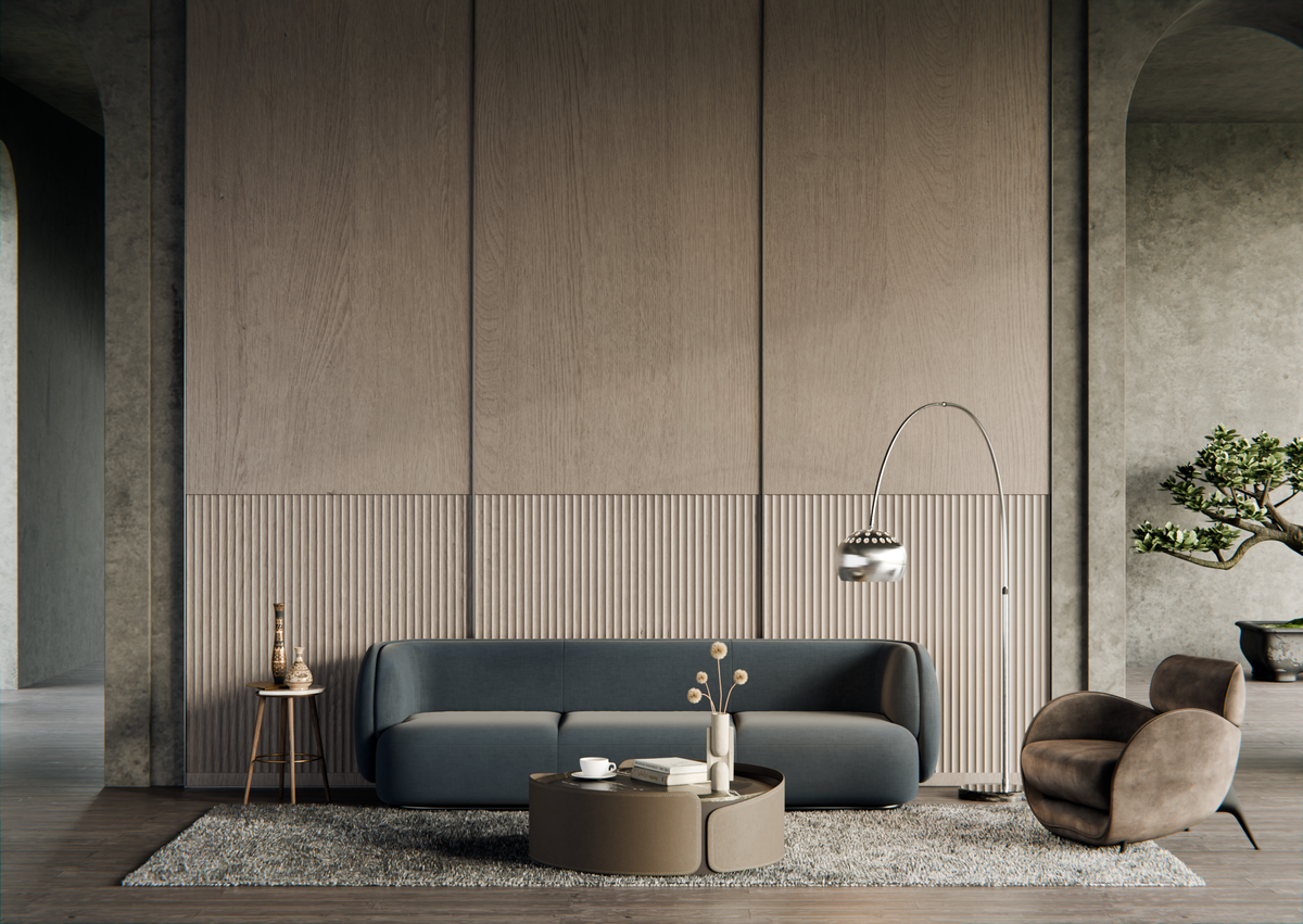 Modern living room with a gray sofa, round coffee table, and armchair against a neutral wall.