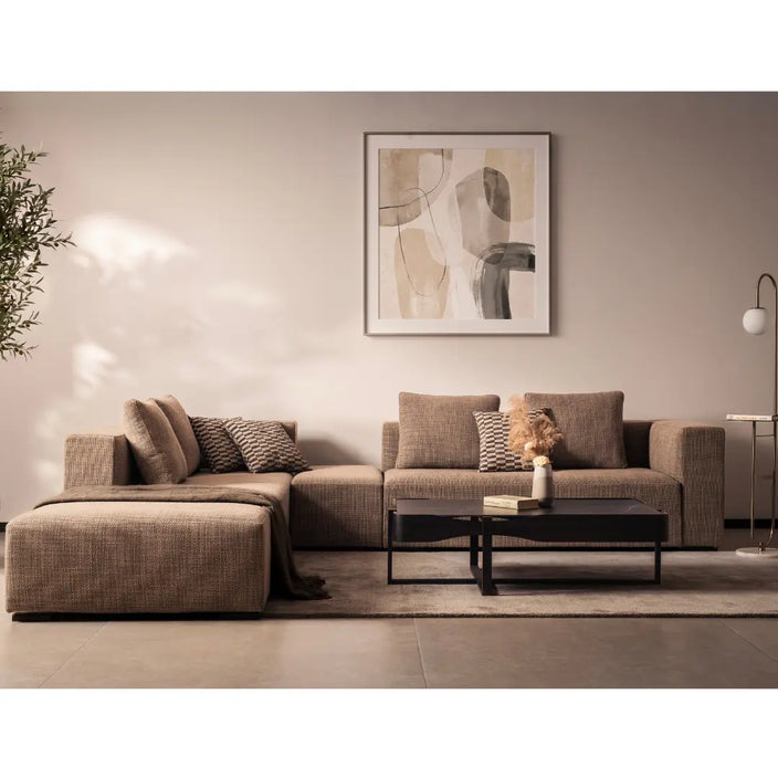 Modern living room with a brown sectional sofa, coffee table, and abstract art on the wall.