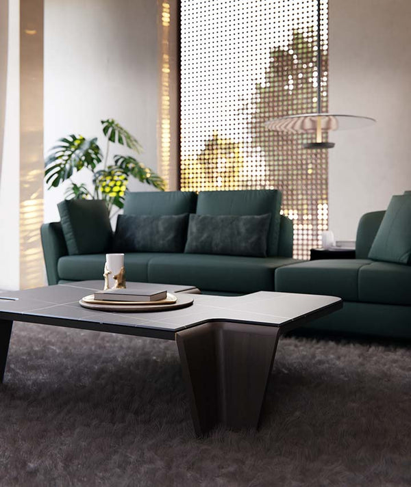 Modern living room with a green sectional sofa and a stylish coffee table.